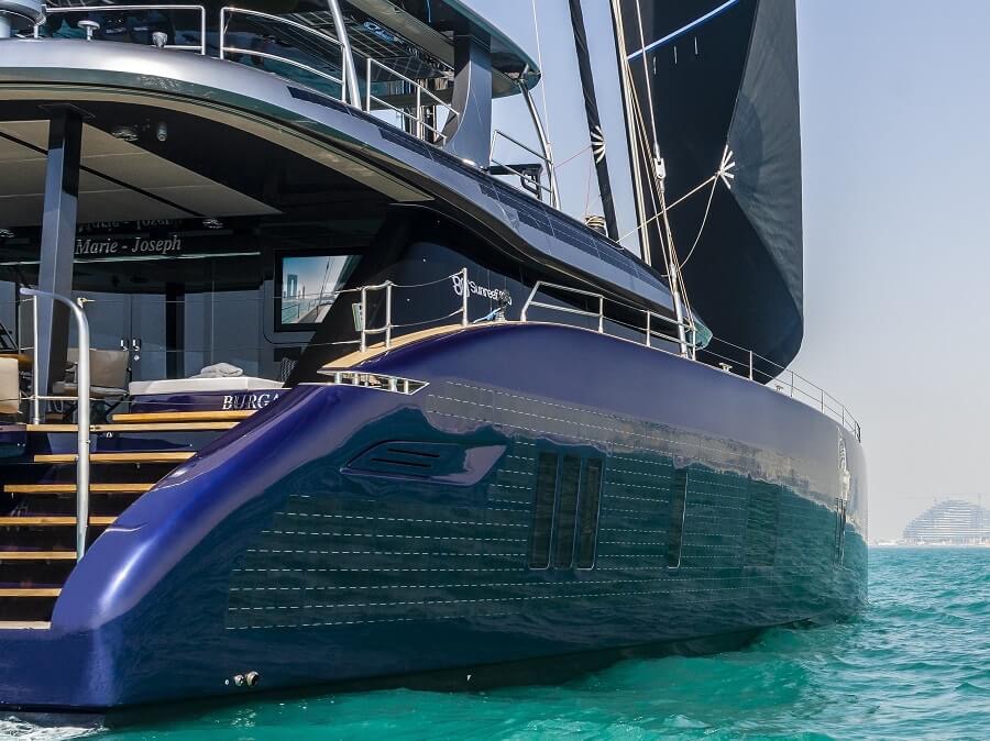 S/Y Lingzhi's transom and solar-clad hull at anchor