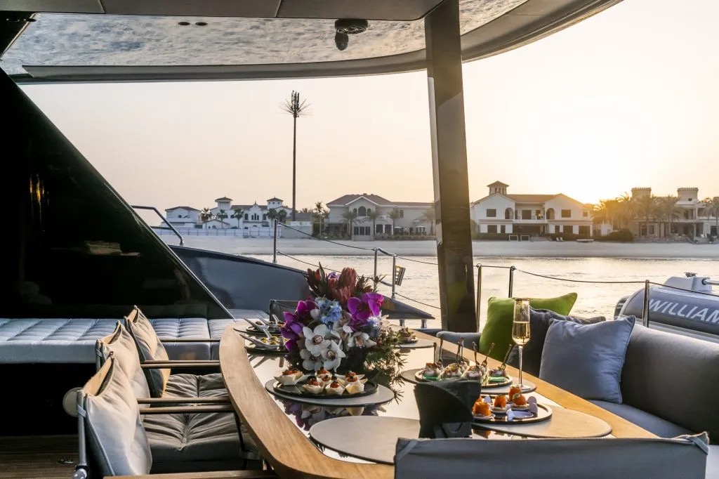Canapes and champagne laid out in the cockpit at sunset aboard S/Y Lingzhi